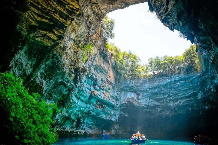 Wooden boardwalk and limestone formations inside Paradise Cave