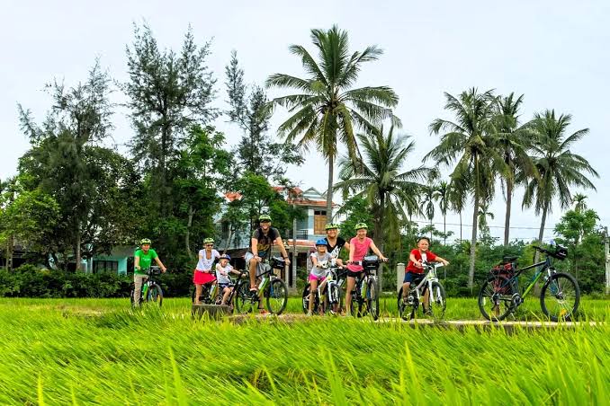 Group enjoying a countryside cycling tour in Hoi An